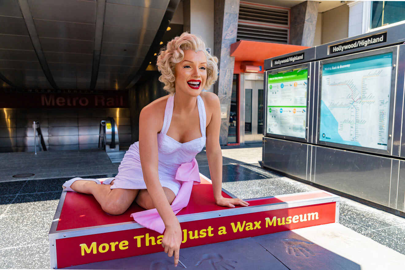 a statue of a Marilyn Monroe sitting on top of a red box