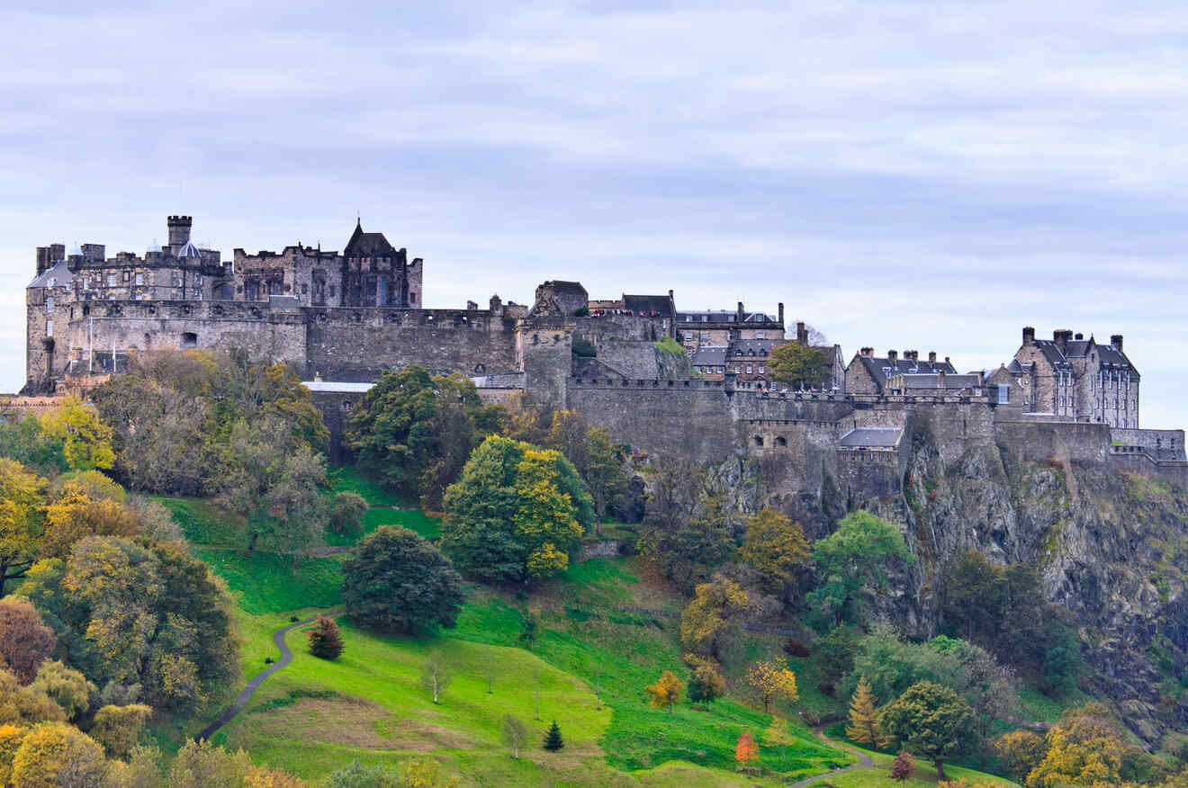 a castle on top of a hill surrounded by trees