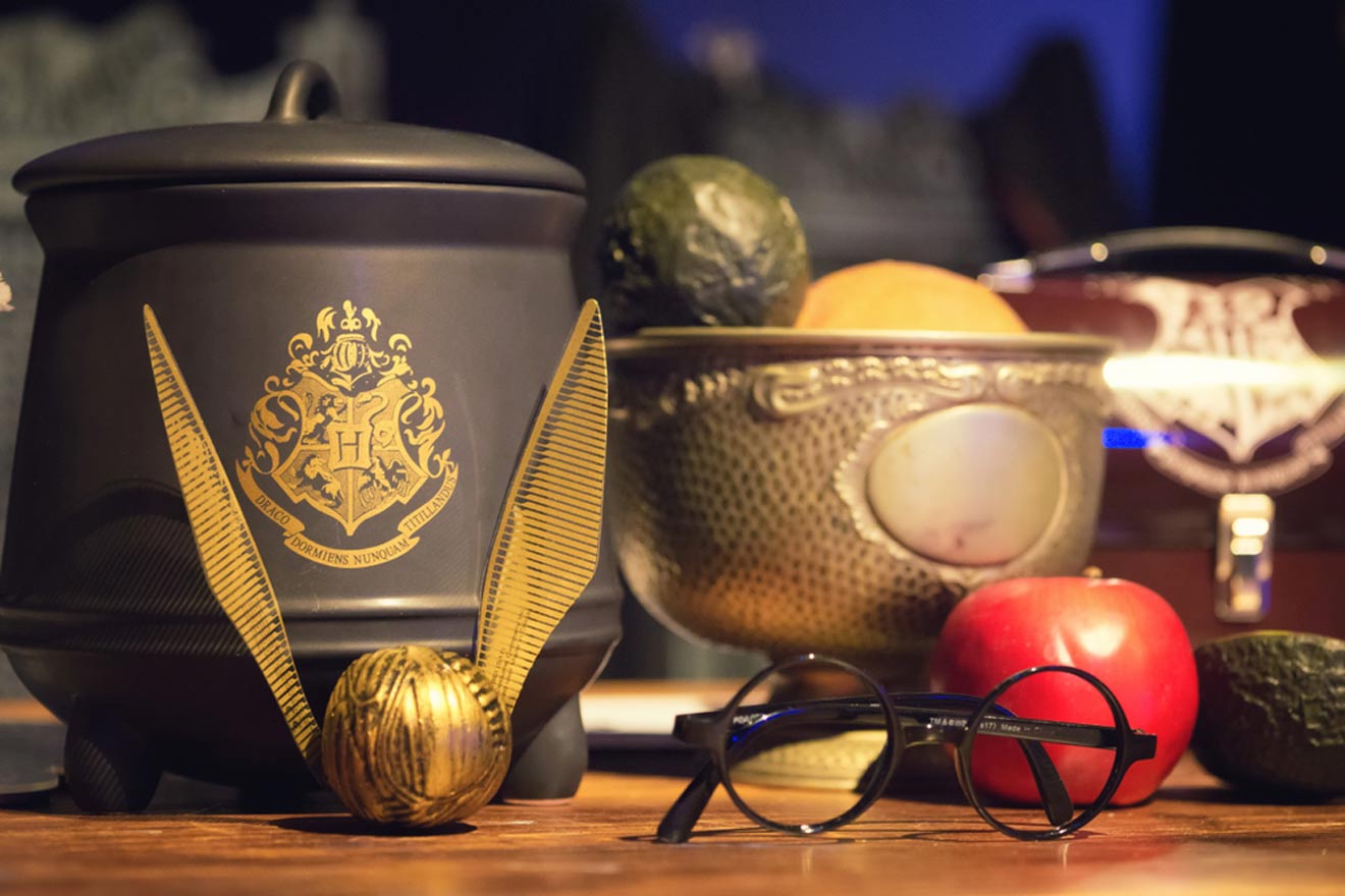 a table topped with bowls with quidditch balls and a pair of glasses