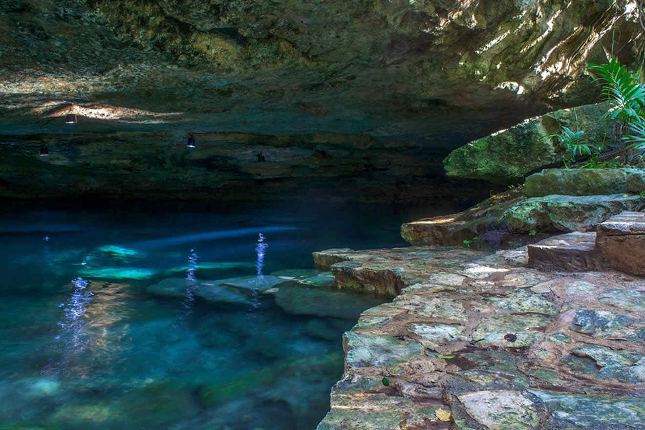 a body of water in a cave surrounded by rocks