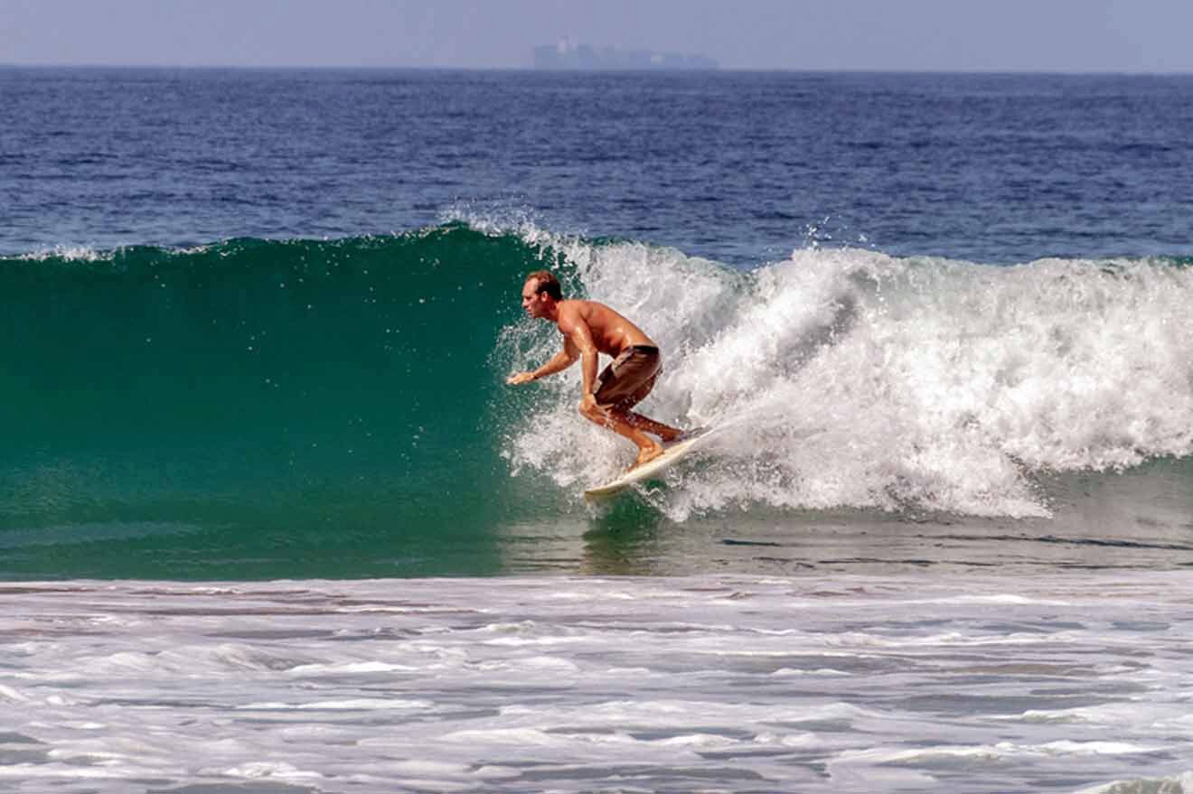 surfer in the ocean breaking a wave