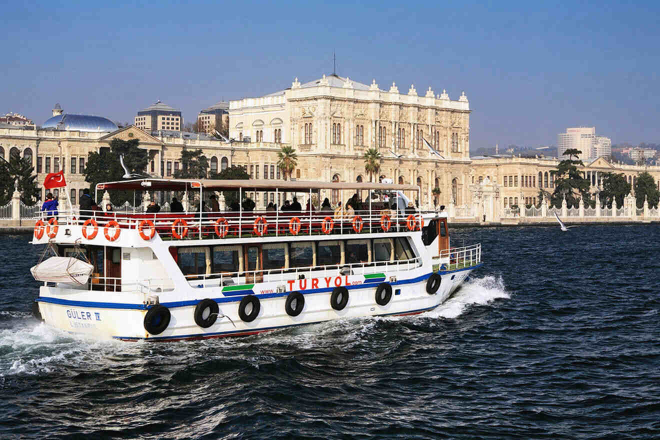 a large white boat with people on it in the water