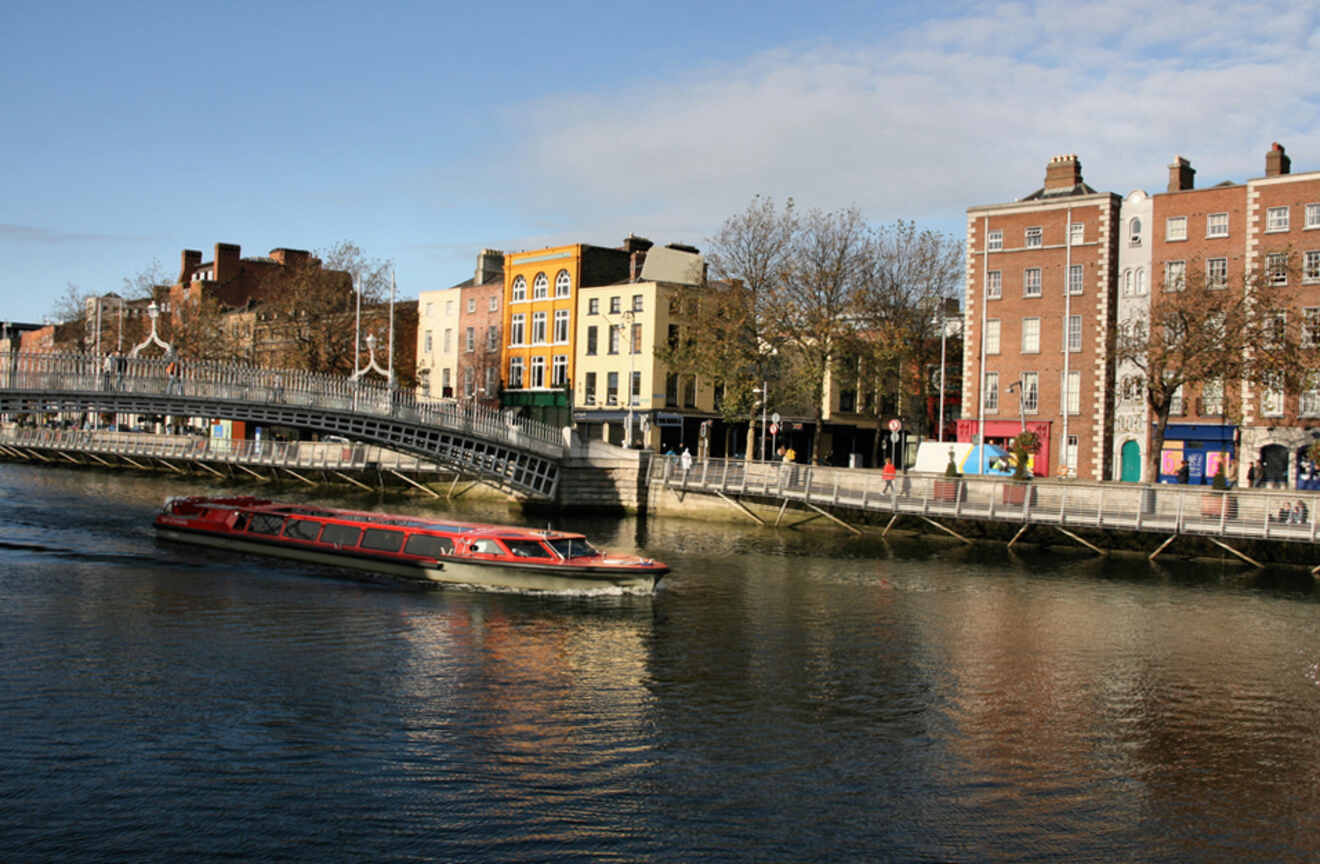 a boat traveling down a river next to tall buildings