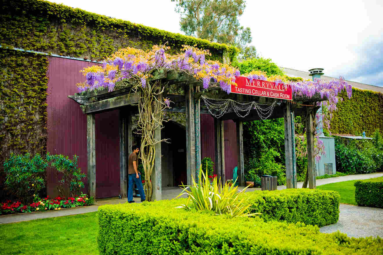 entrance to a tasting cellar with lots of flowers and greenery