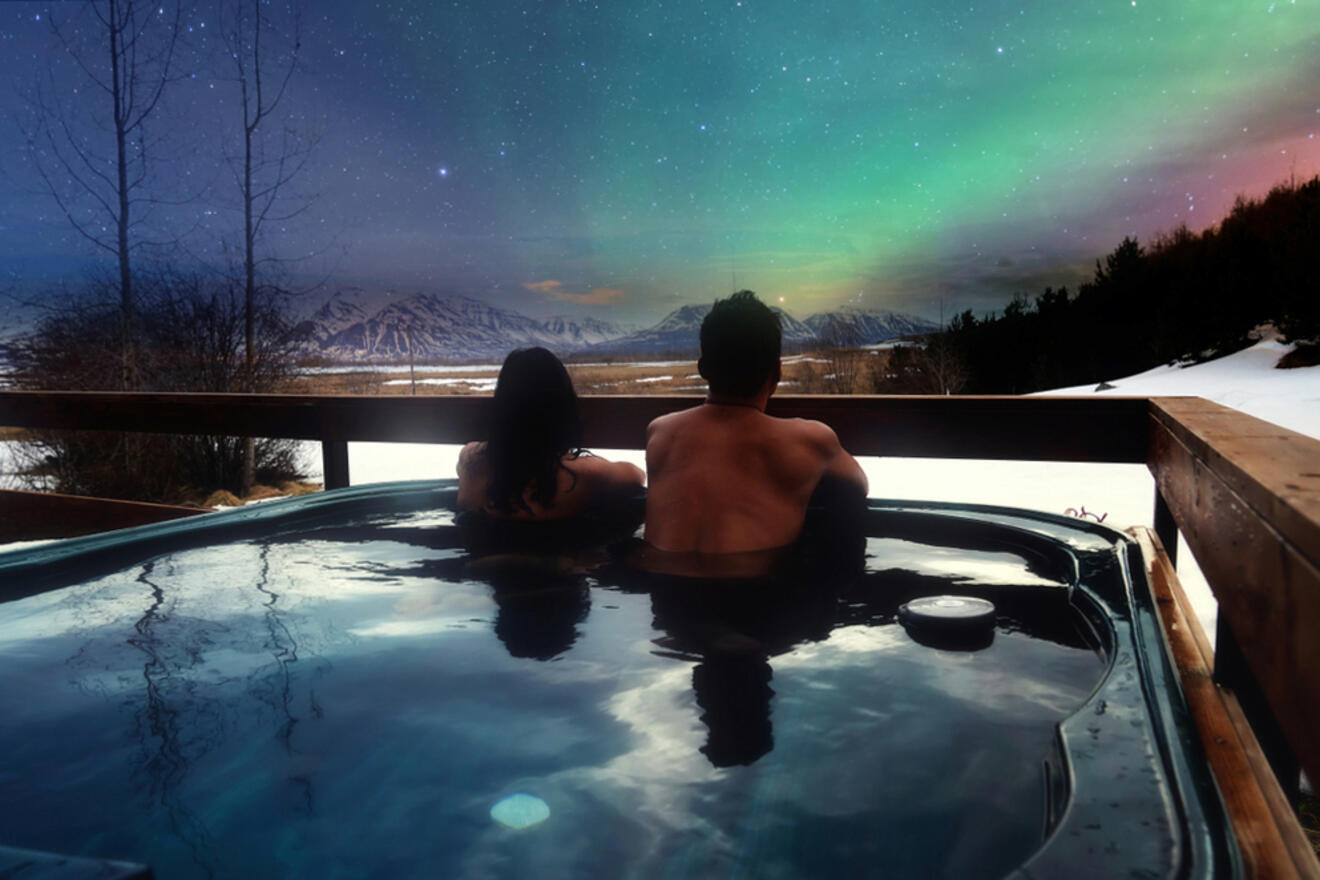 couple watching the aurora borealis from a jacuzzi