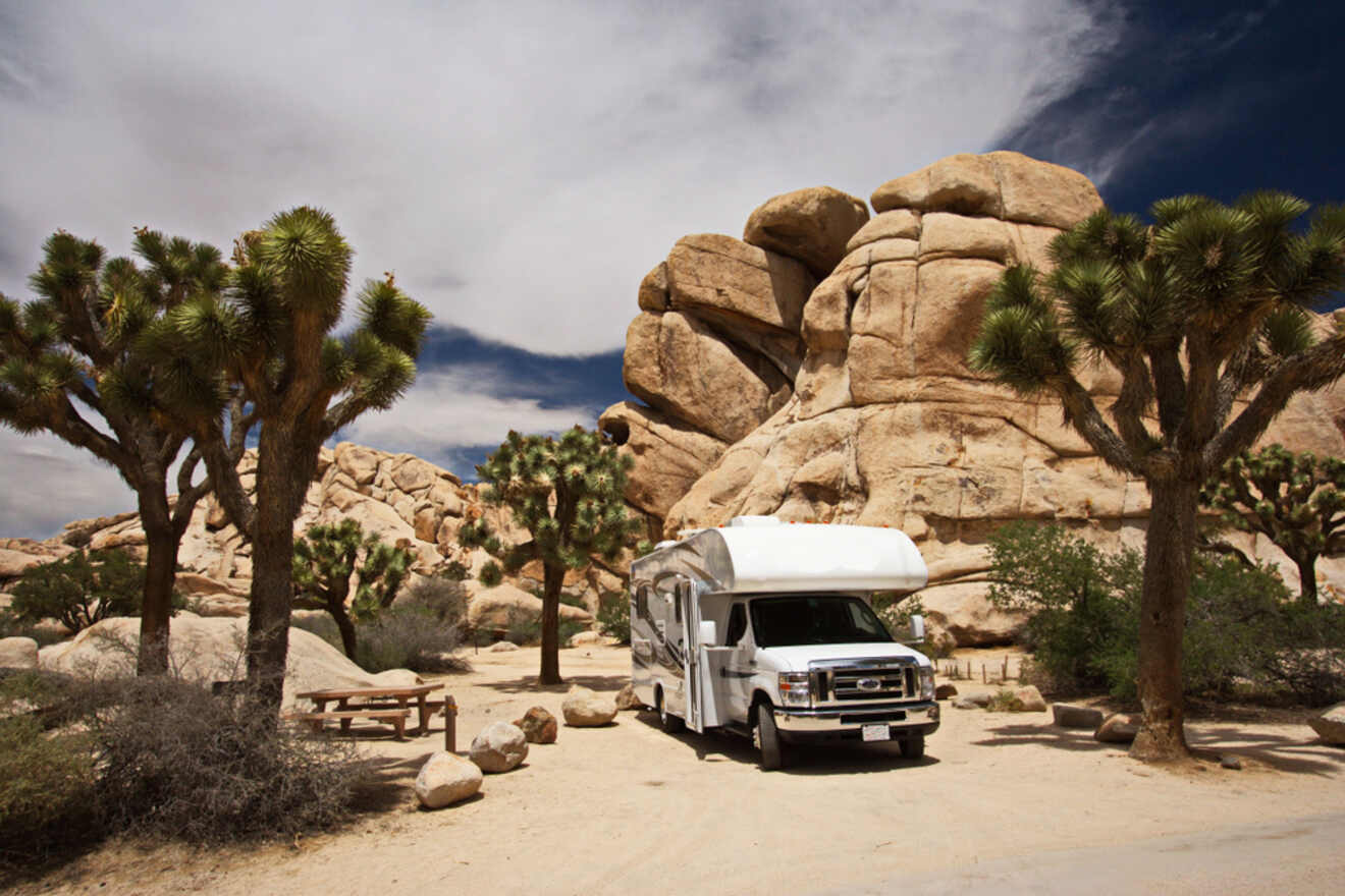 a truck parked in front of a large rock formation