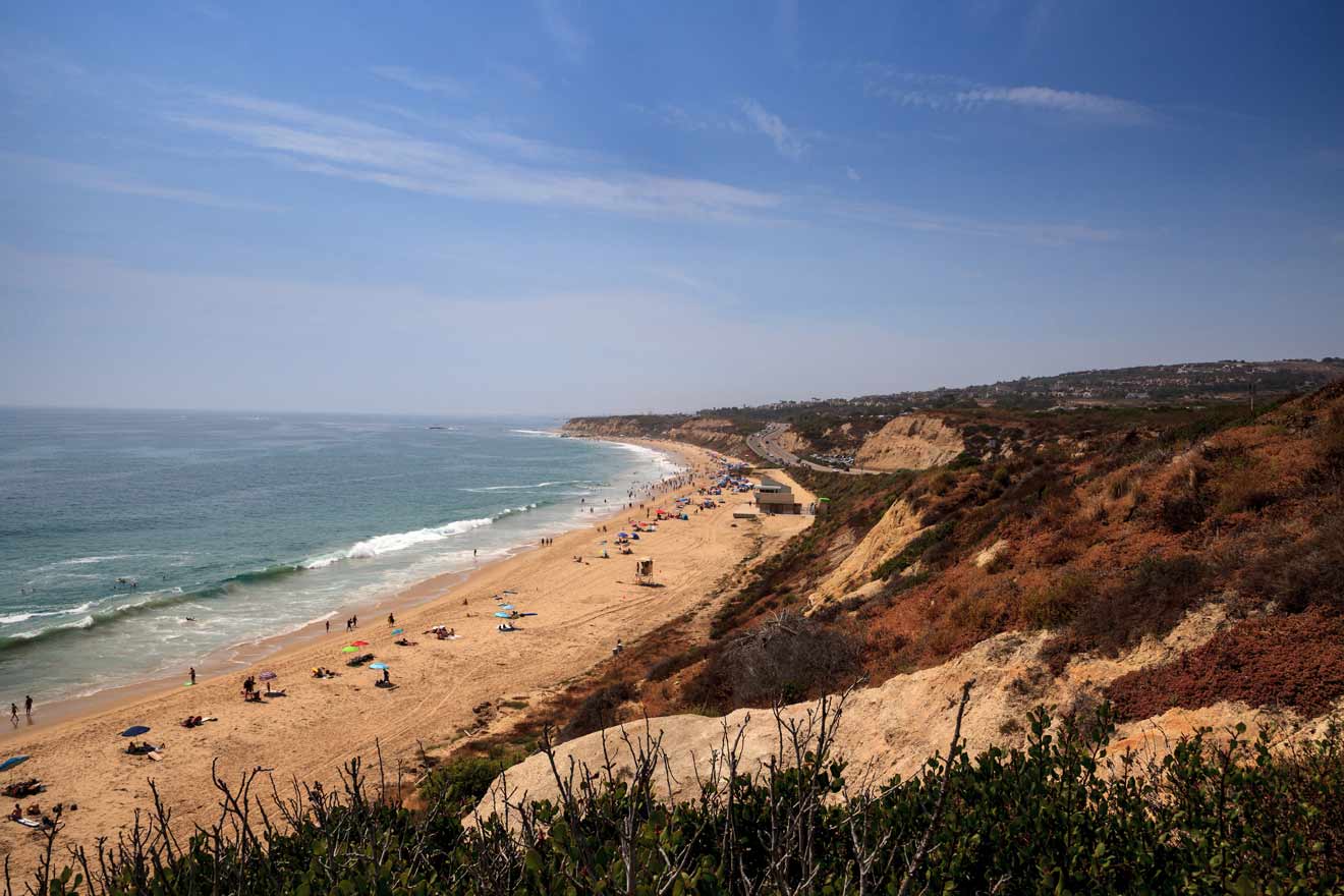 a group of people on a beach next to the ocean