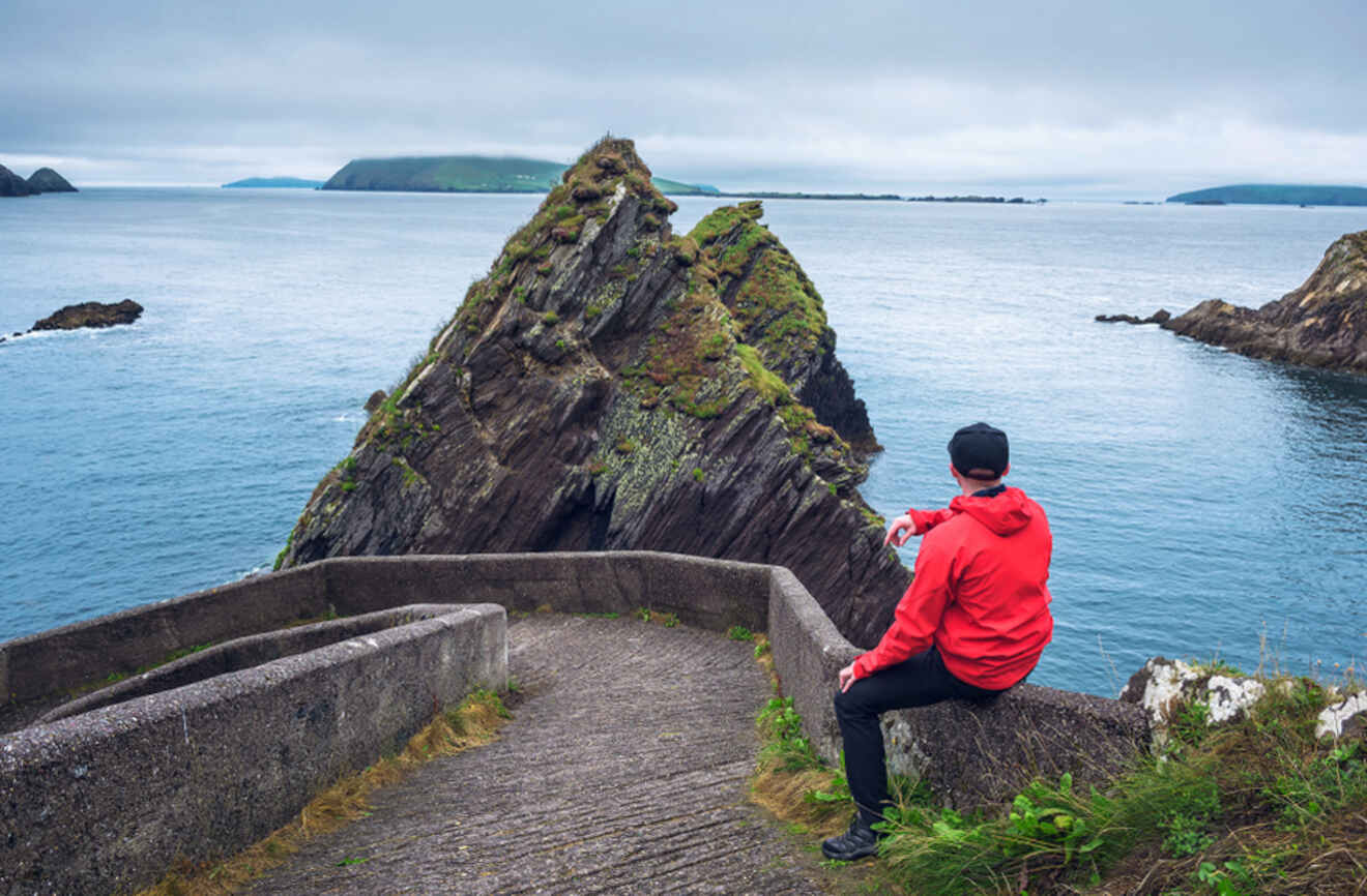 A person looking at cliff rocks