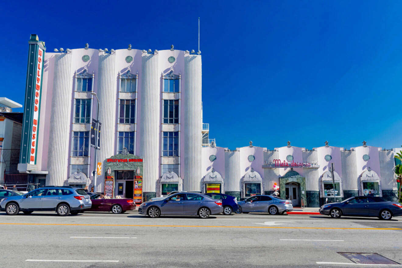 a large white building with cars parked in front of it