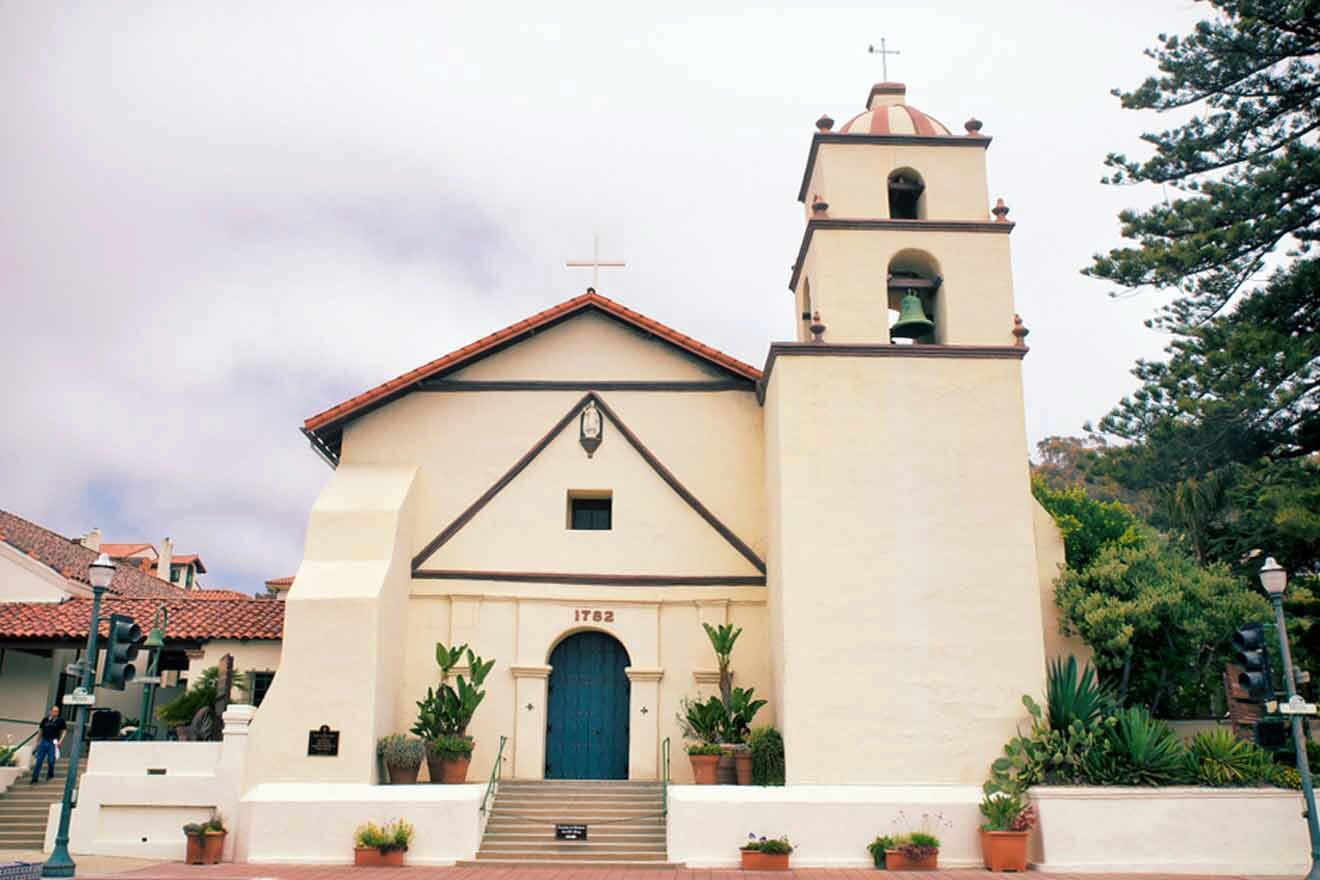 a white church with a blue door and a bell tower