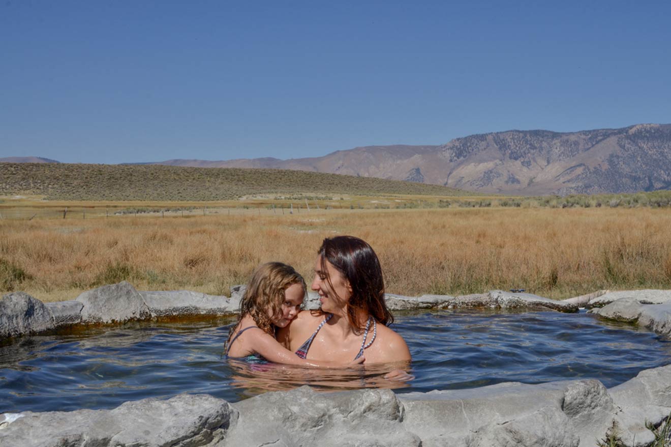 a woman and a child are in a hot spring