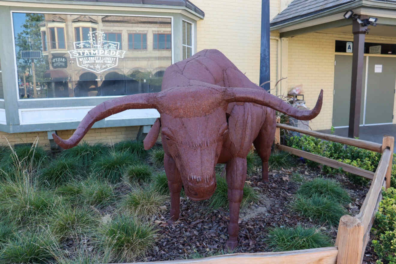 a bull statue in front of a window