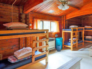 a hostel's bedroom with a couple of bunkbeds