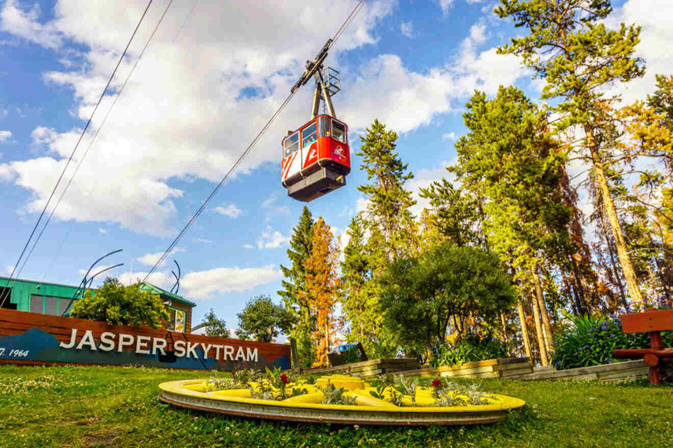 a red and white ski lift above a lush green park