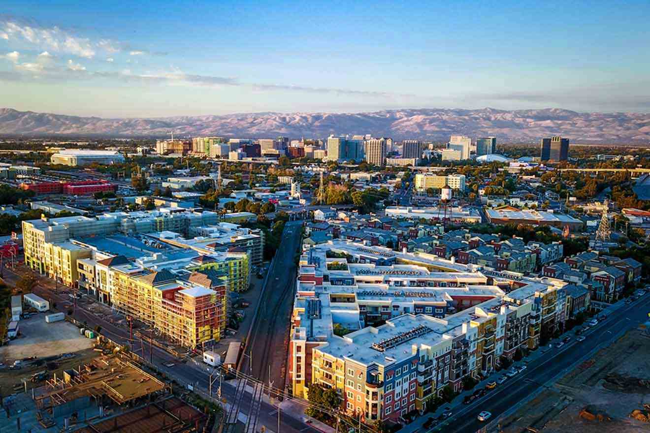 an aerial view of a city with mountains in the background