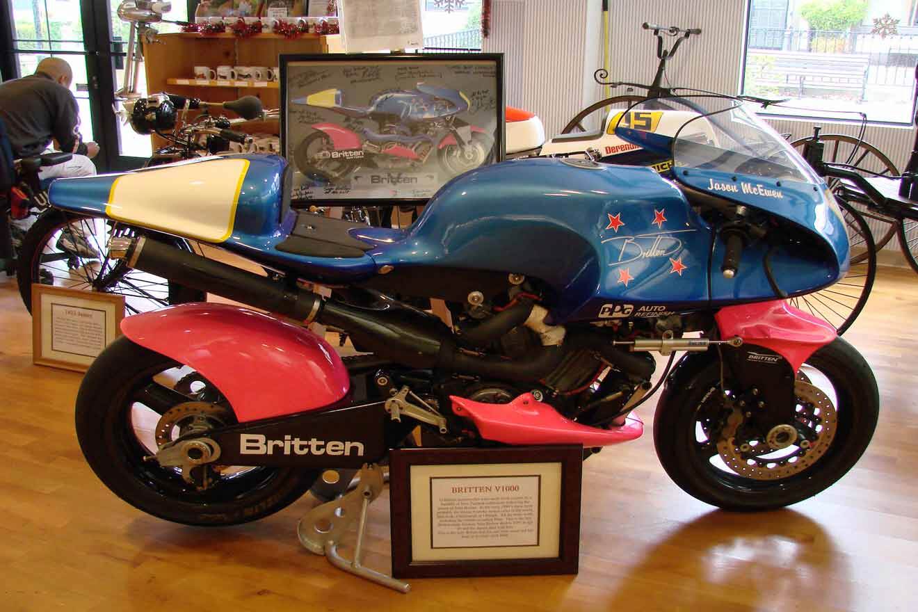 a blue and red vintage motorcycle on display in a room