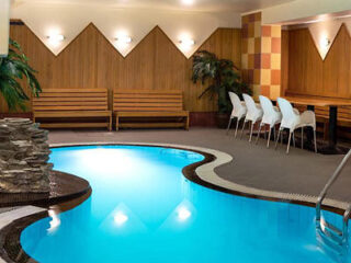 indoor swimming pool with benches and chairs
