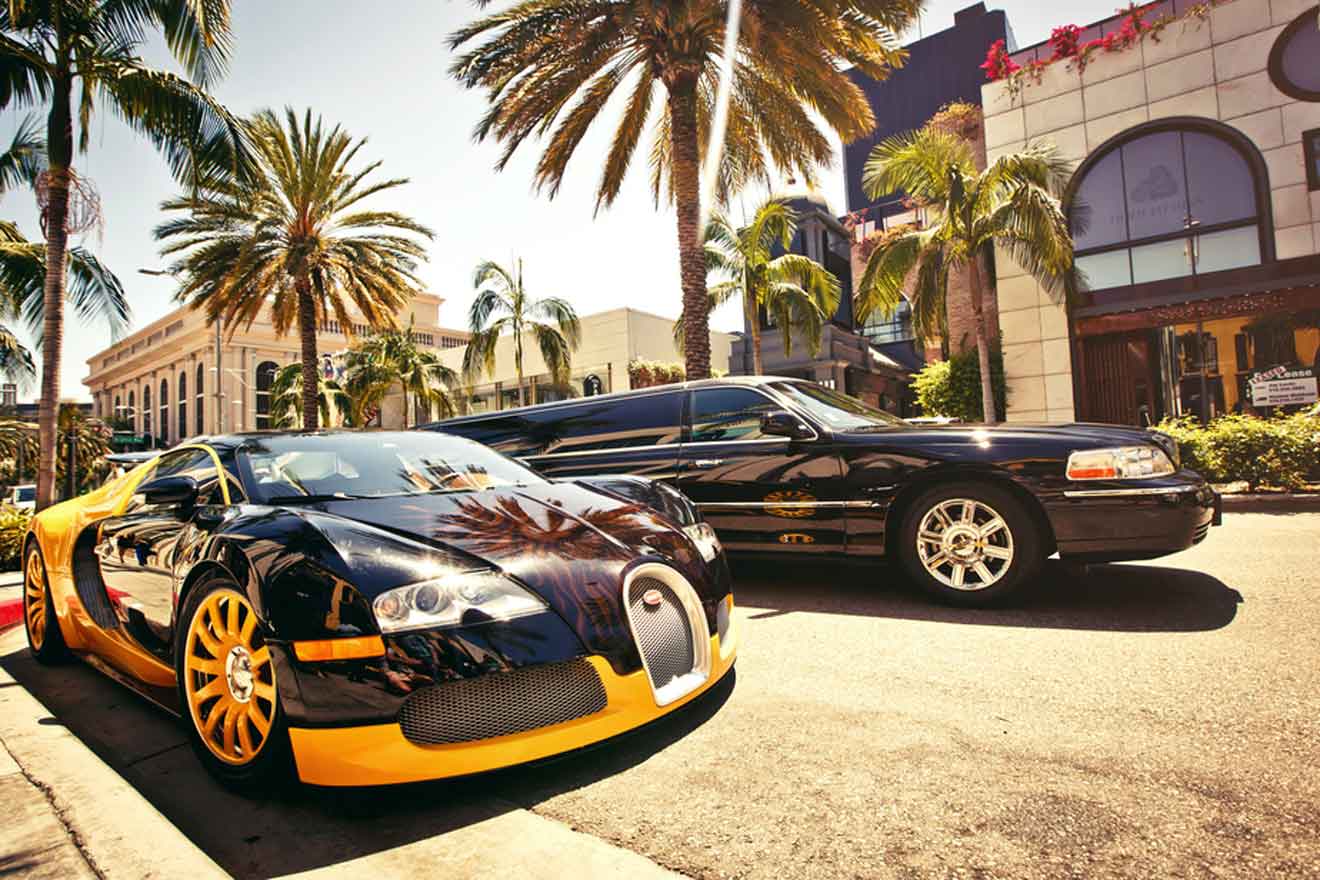 a couple of luxury cars parked next to each other on a street