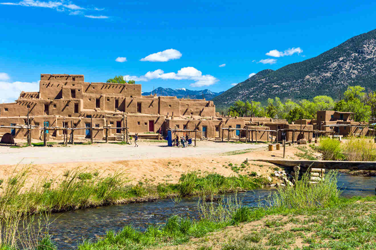 a large brown building sitting next to a river