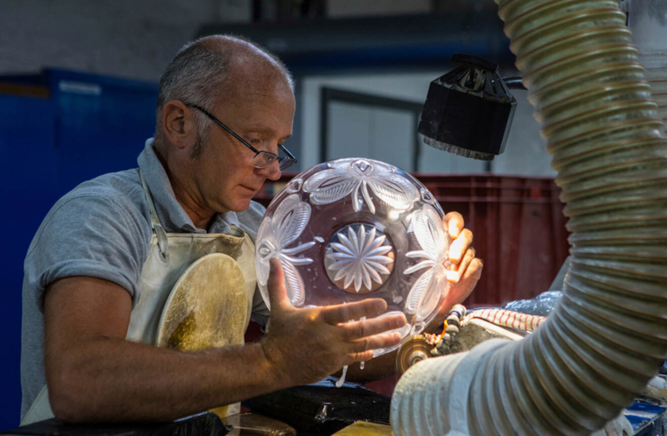 A person working on a glass vase