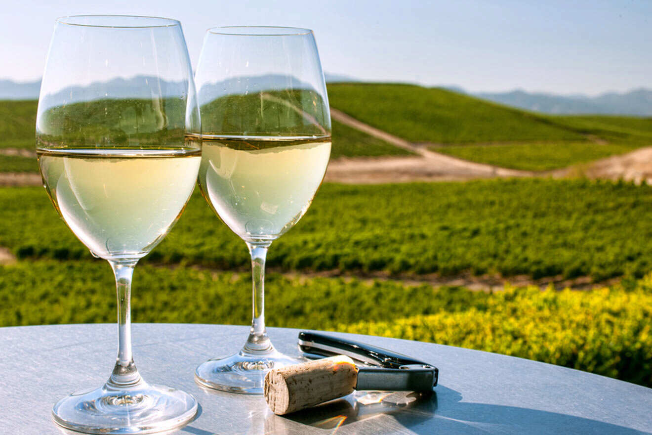 a couple of glasses of wine sitting on top of a table