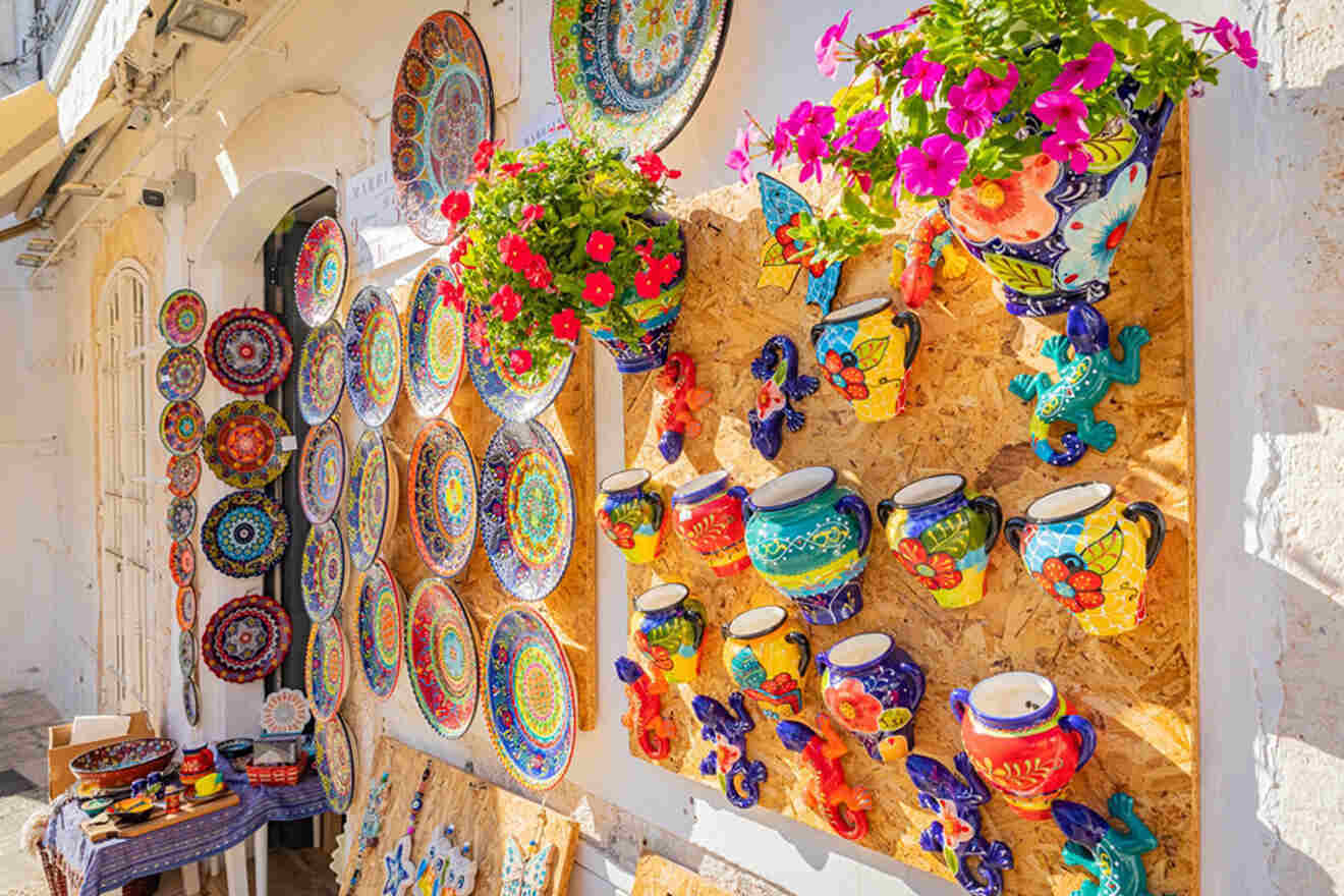 a colorful display of pottery and flowers on a wall