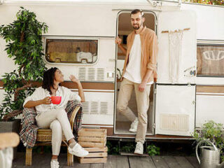couple sitting in front of an RV