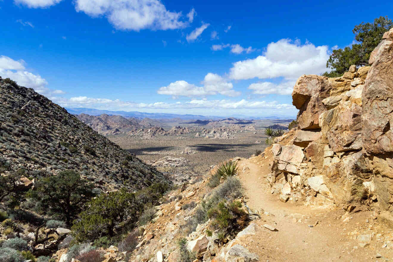 a view of a rocky mountain with a blue sky in the background