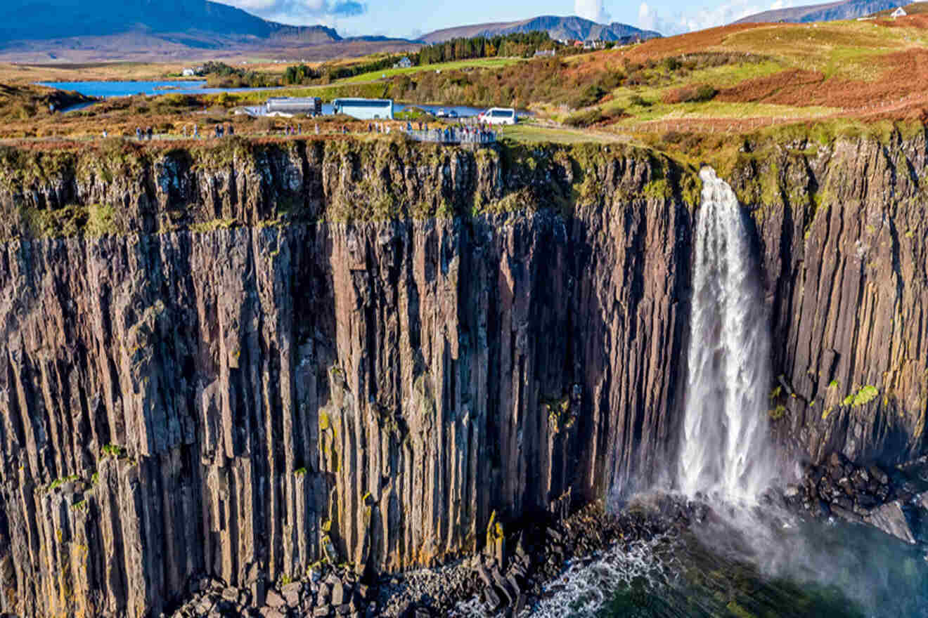 an aerial view of a waterfall and a cliff