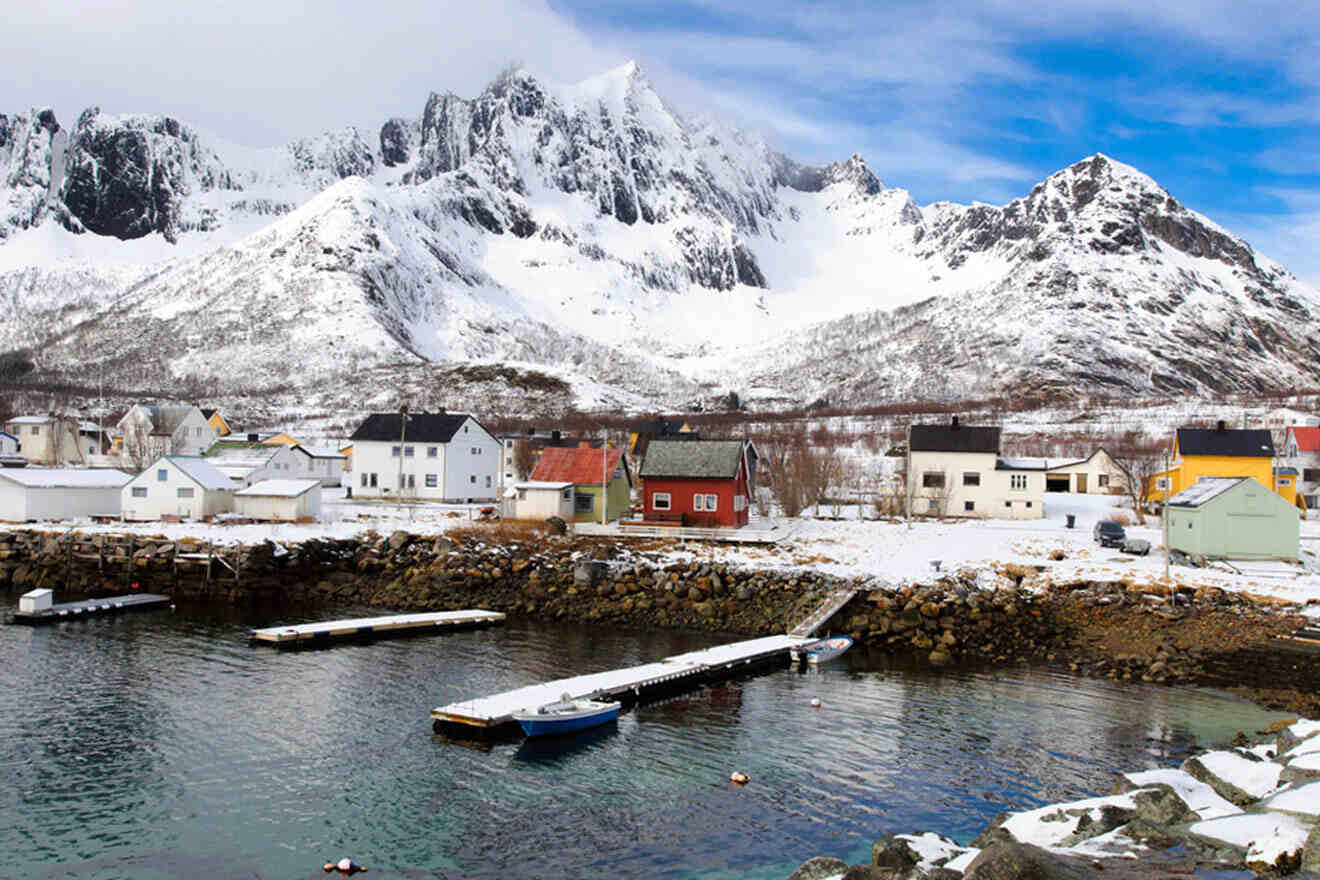 a small town by the lake and with a mountain in the background