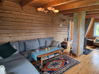 a cabin's living room with couch and table