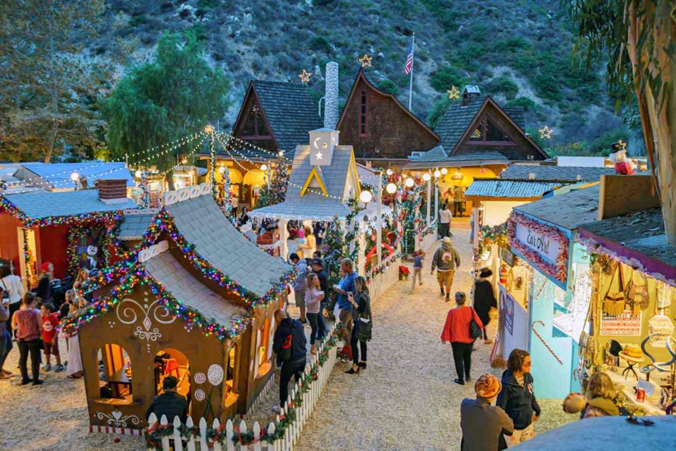 a crowd of people walking around a christmas market