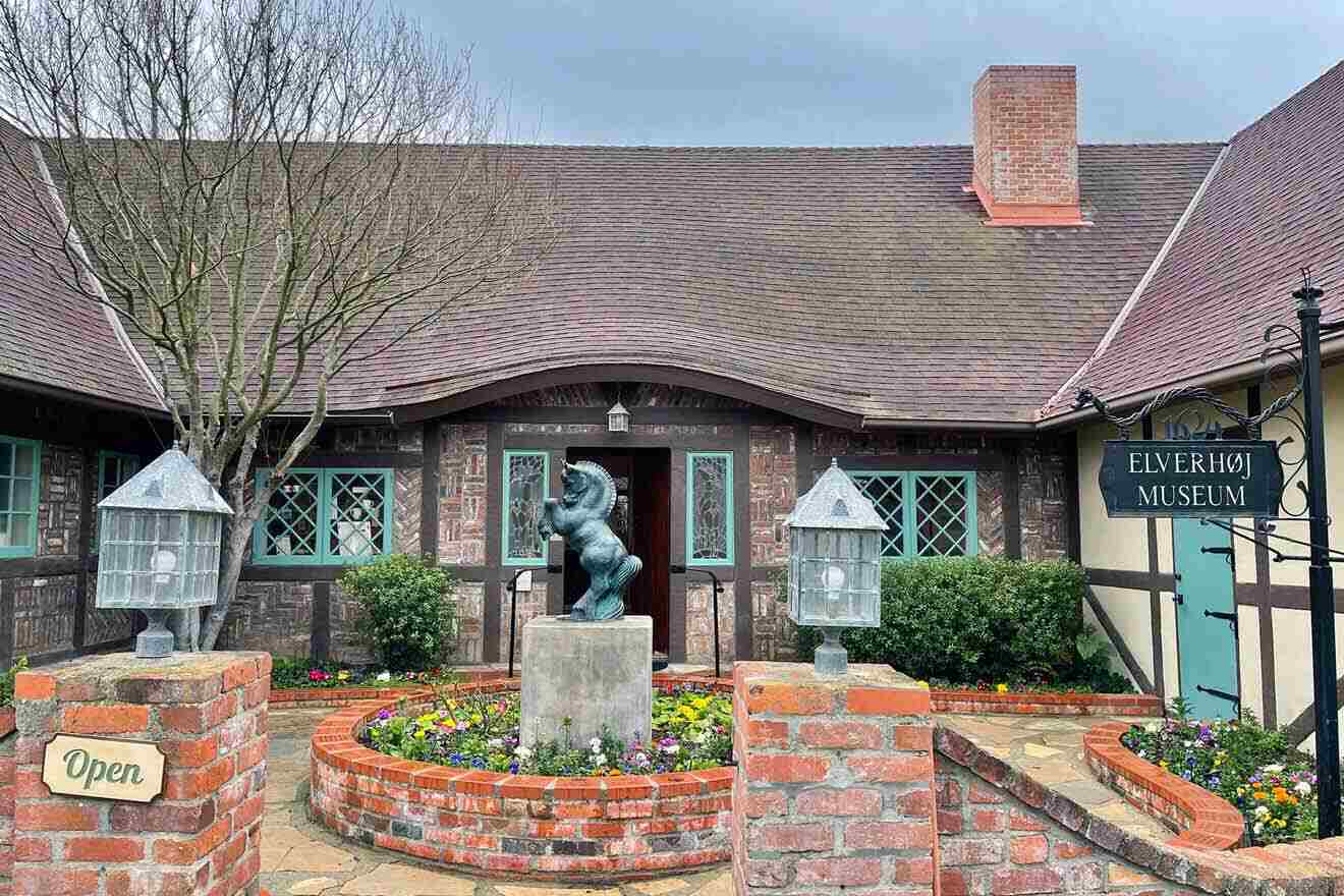 a brick building with a statue of a horse in front of it
