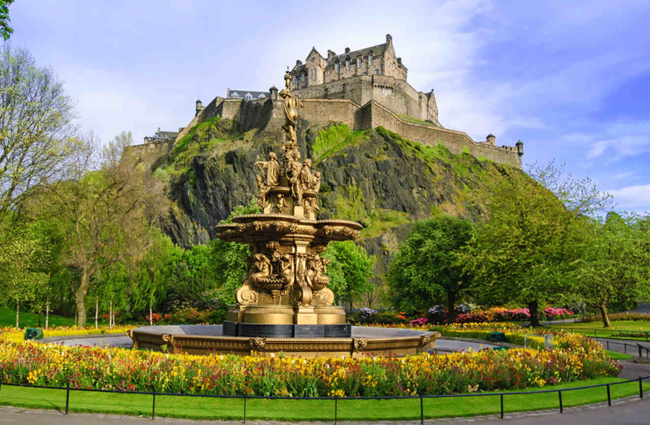 a fountain in a park with a castle in the background