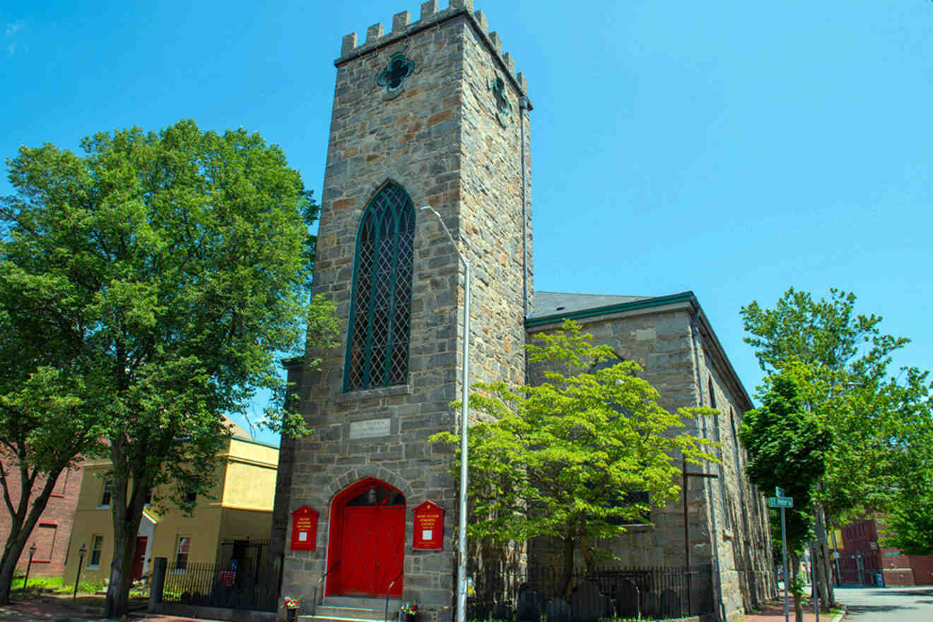 a church with a red door and a tall tower
