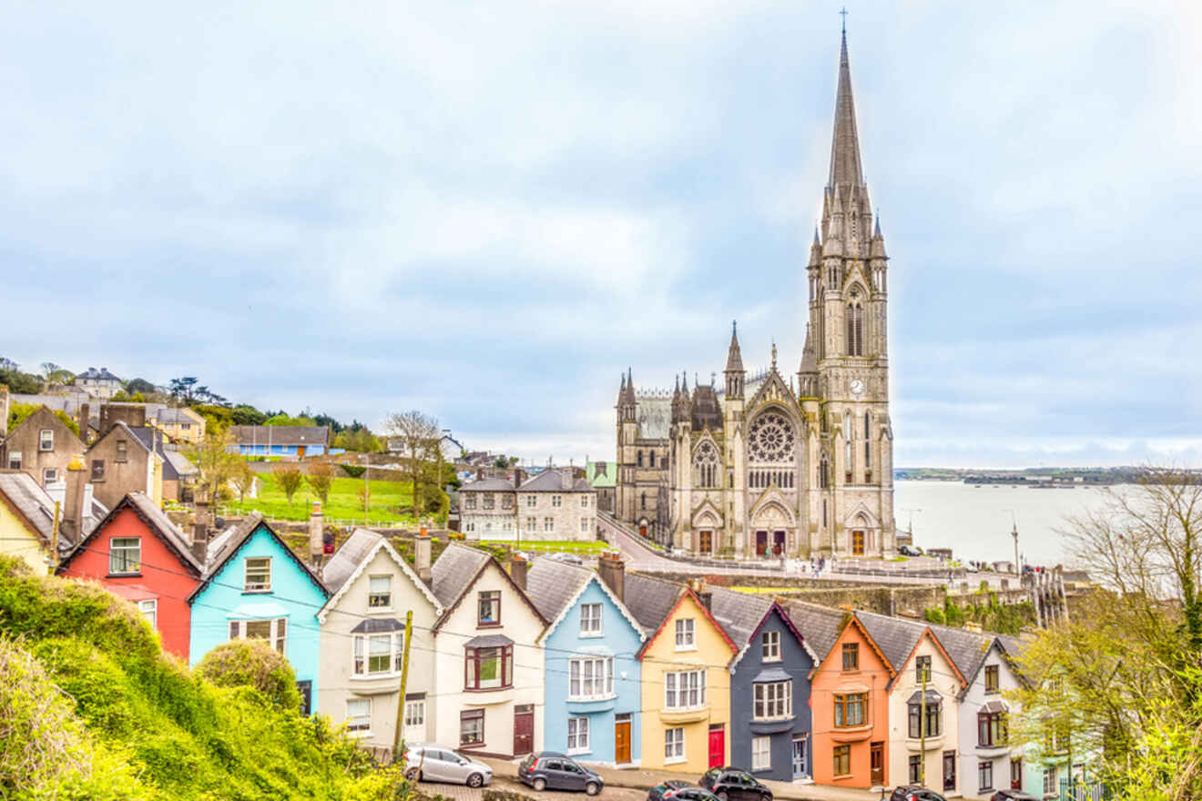 a row of colorful houses with a church in the background