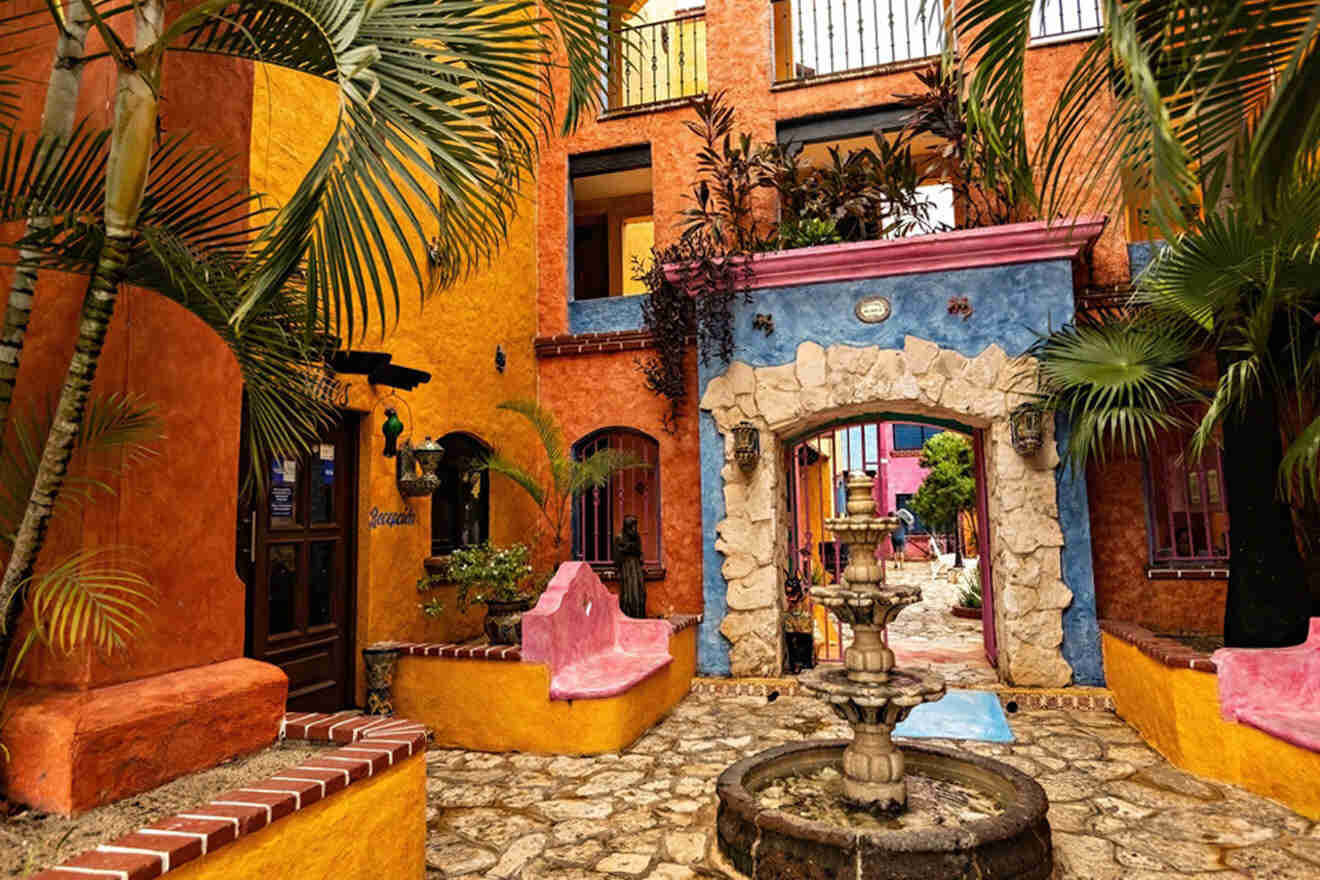 a courtyard with a fountain surrounded by palm trees