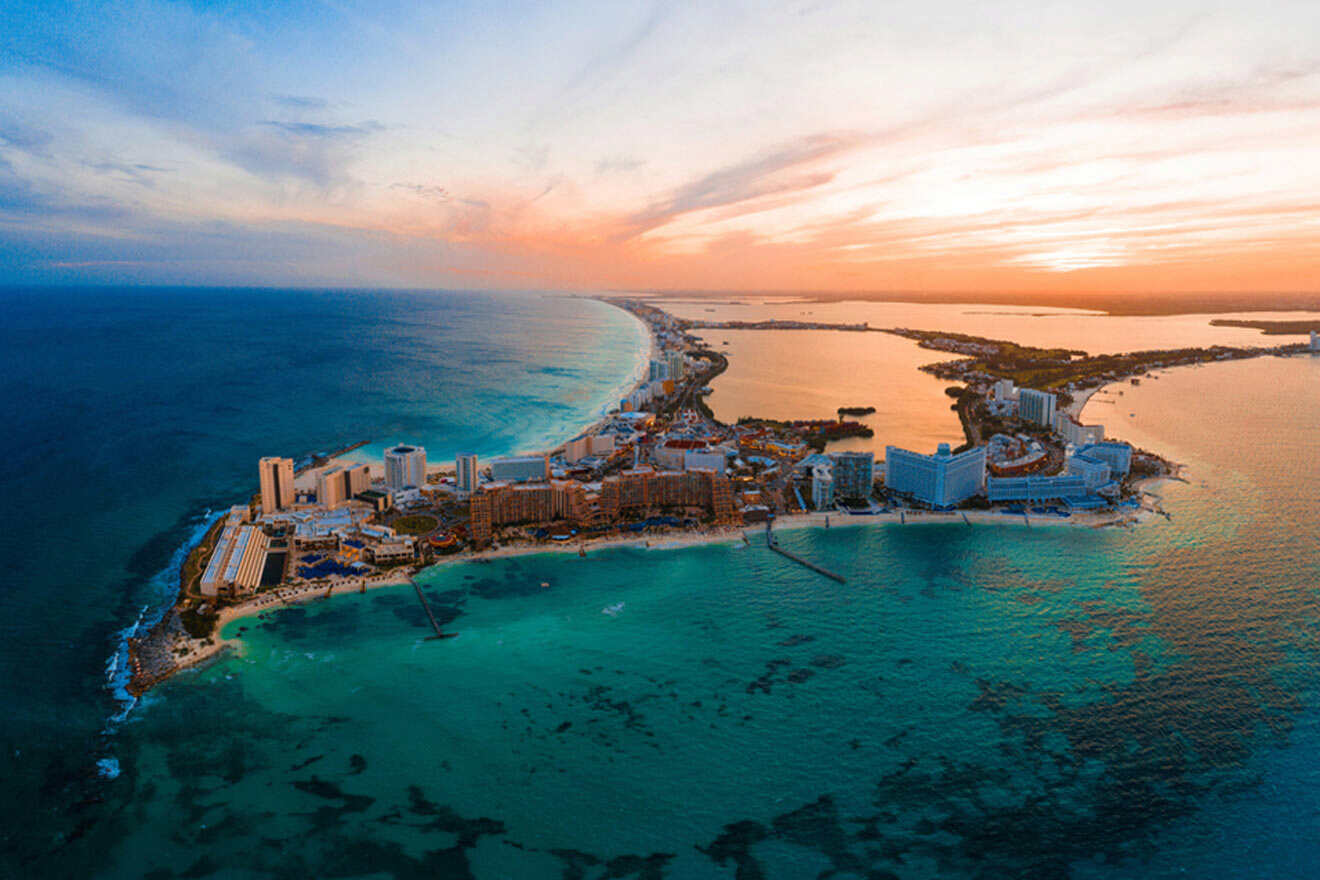 Panoramic view of Cancun's skyline at dusk, with the hotel zone brightly lit, reflecting in the tranquil waters of the Caribbean Sea, embodying the lively spirit of this coastal city