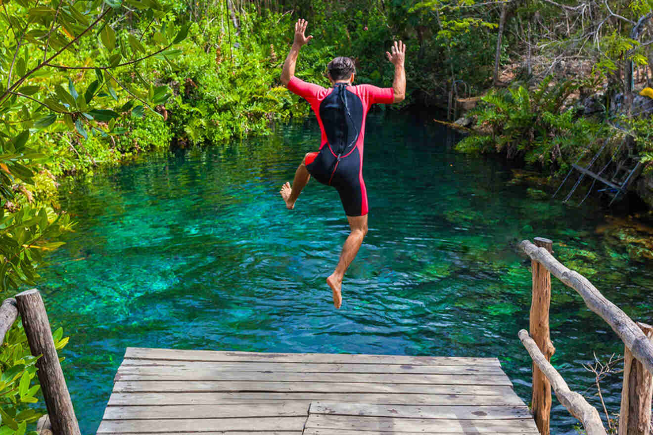 a man jumping in the water from a deck