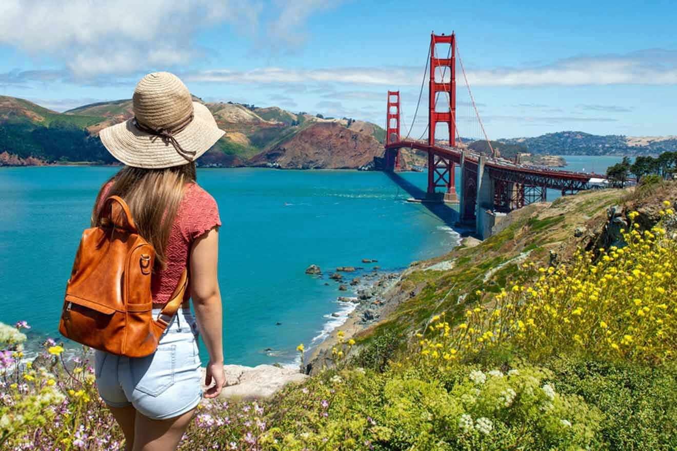 a woman with a backpack is looking at the golden gate bridge