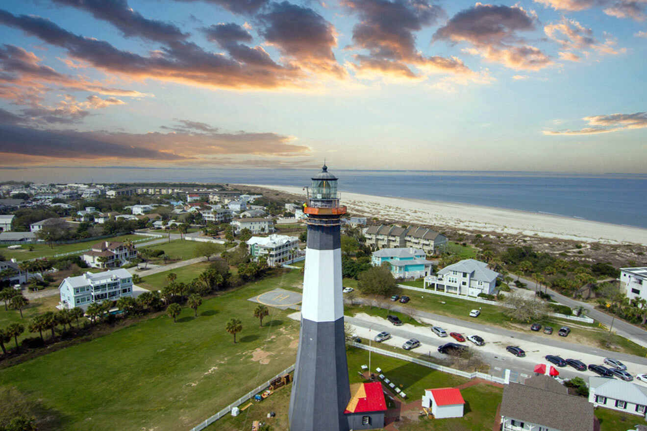 an aerial view of a lighthouse on the beach
