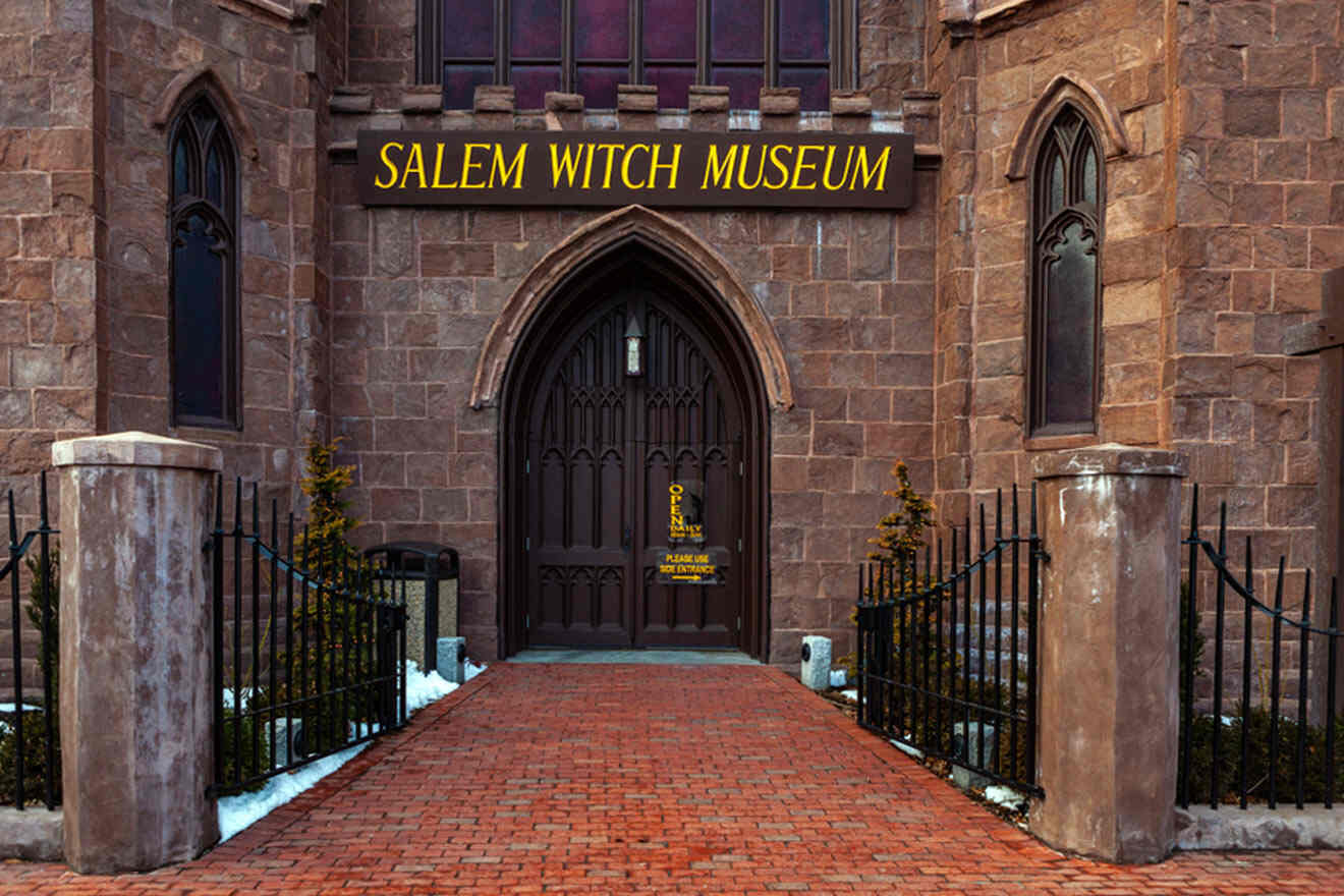a brick building with a black gate and a sign that says salem witch museum