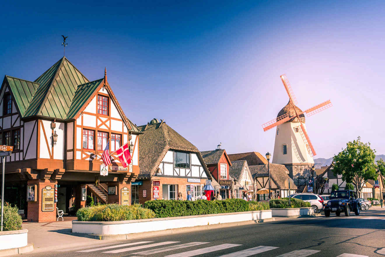 a row of houses with a windmill in the background