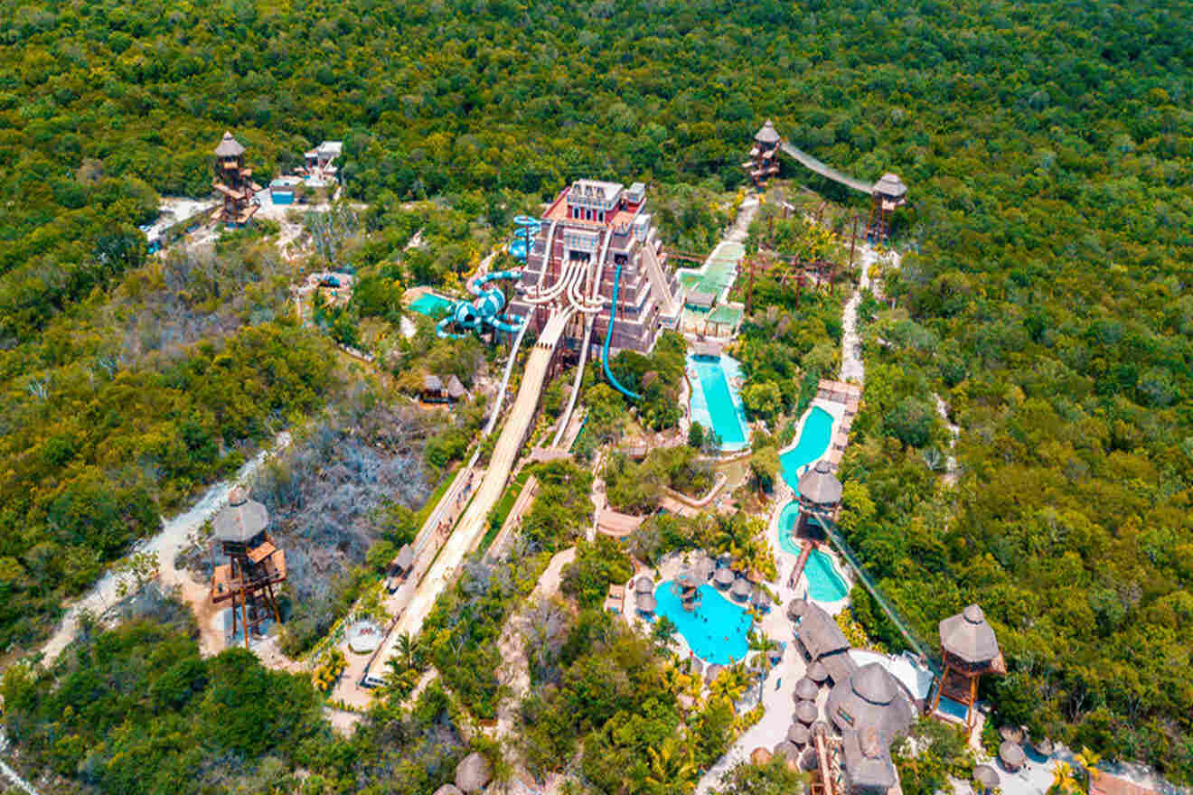an aerial view of a resort with waterpark surrounded by trees