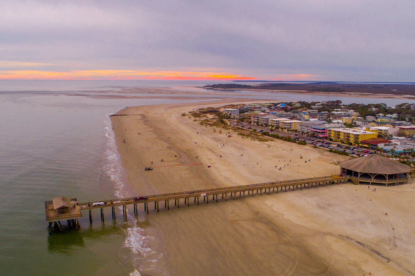 an aerial view of a beach with a pier