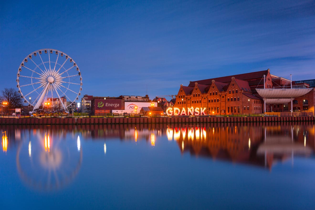 a large ferris wheel next to a lake