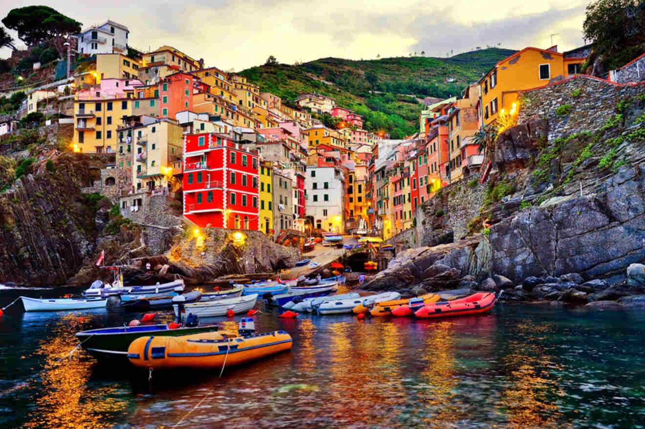 a group of boats floating near the coast and colored houses on background