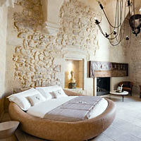 A round bed in a room.