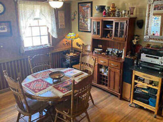 A kitchen with a wooden table and chairs.