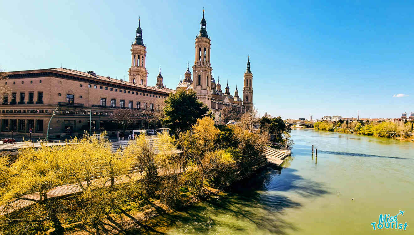 A view of a river with a cathedral in the background.